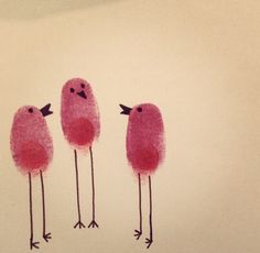 three pink birds standing next to each other on top of a white wall with red paint