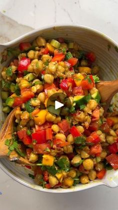 a white bowl filled with vegetables on top of a table