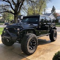 a black jeep parked in front of a house