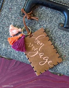 a luggage tag that says, don't worry the edge with tassels hanging from it