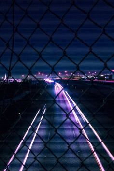 the view from behind a chain link fence at night