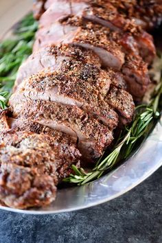 sliced meat on a plate with herbs and seasoning