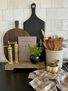 kitchen utensils and cutting boards on a counter