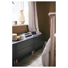 a bed room with a neatly made bed and a book shelf next to a window