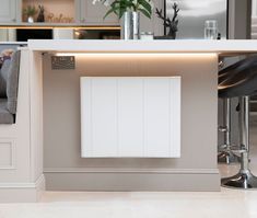 a white cabinet sitting in the middle of a kitchen