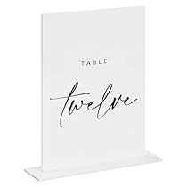 a white table sign with the word table twelve on it's front and side