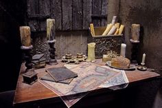 a table topped with lots of different types of candles and other things on top of it