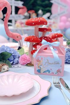 a table set for a princess party with pink flamingos