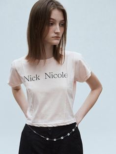 This short-sleeve T-shirt from NICK&NICOLE features the Nick Nicole logo lettering as a focal point. The pintuck detail on the front makes it suitable for statement wear.- Slim fit that makes your body curves accentuated- The cropped length elongating the legs- A versatile item with a vintage yet casual mood 90s Fitted Cropped Crew Neck T-shirt, Stretch Cropped T-shirt With Text Print And Crew Neck, 90s Style Pink T-shirt With Text Print, Pink Novelty Crew Neck T-shirt, Pink Crew Neck Novelty T-shirt, Body Curves, Cropped T Shirt, Pin Tucks, Crop Tshirt