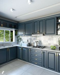 a kitchen with blue cabinets and white counter tops, along with potted plants on the window sill