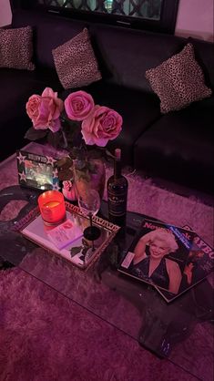 a living room filled with lots of furniture and flowers on top of a coffee table