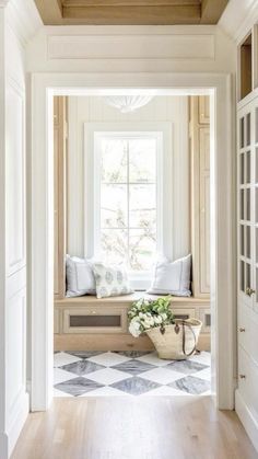 an open door leading into a room with white walls and wood trimming on the windowsill