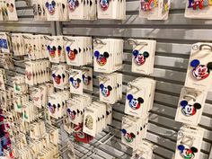 many mickey mouse magnets are hanging on the wall