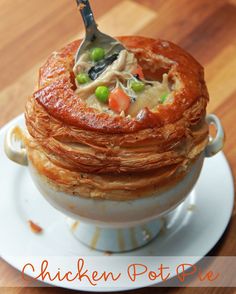 a stack of food sitting on top of a white plate with a spoon in it