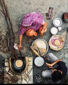 an overhead view of people cooking food on the ground