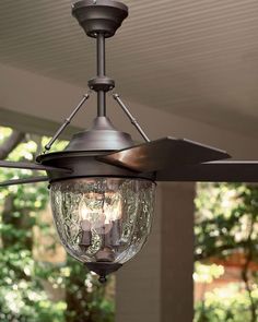 an outdoor ceiling fan with two lights on it