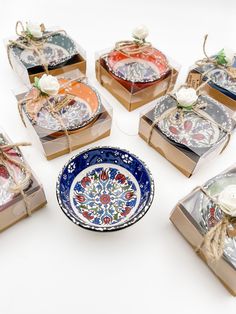 six decorative plates in boxes tied with twine