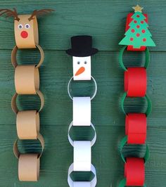 some paper chains are attached to the side of a wooden wall with christmas decorations on them