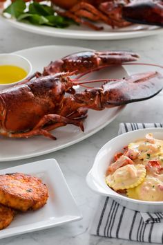 lobsters and potatoes are served on white plates