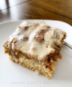 a close up of a piece of cake on a plate with a fork in it