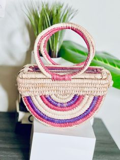 The Ọnwa Raffia Handbag – House of Okara Chic Multicolor Handwoven Shoulder Bag, Bohemian Pink Handwoven Straw Bag, Pink Bohemian Handwoven Straw Bag, Chic Multicolor Bucket Straw Bag, Chic Multicolor Handmade Straw Bag, Multicolor Straw Bag With Bamboo Handle For Vacation, Pink Bohemian Rectangular Straw Bag, Chic Multicolor Rectangular Straw Bag, Pink Vacation Bag With Bamboo Handle