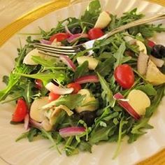 a white plate topped with salad and a fork