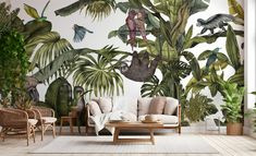 the living room is decorated with tropical plants and birds on the wall, along with two sofas