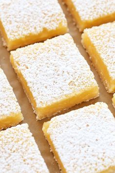 several pieces of cake sitting on top of a pan covered in powdered sugar and sprinkled with icing