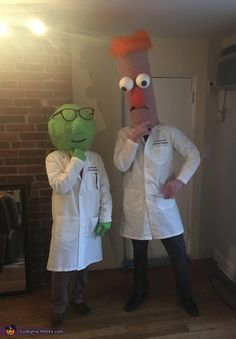 two people in white lab coats standing next to each other