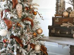 a white christmas tree with gold and red ornaments