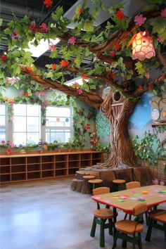 a classroom with wooden tables and benches under a tree decorated with flowers on the ceiling