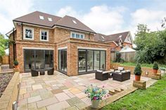 a brick house with patio and seating area