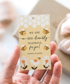 a person holding up a card that says, we are bee - lovely thank you