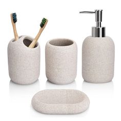 three pieces of bathroom accessories including soap dispenser, toothbrush holder and soap dish