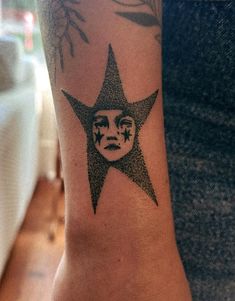 a person with a tattoo on their arm has a face in the shape of a star