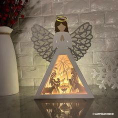 a lighted angel on top of a table