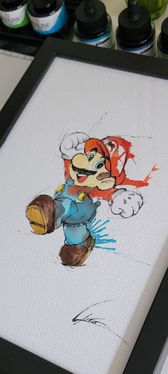 a drawing of a cartoon character is shown in front of some other paint and markers