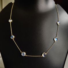 "ITEM DESCRIPTION: >>The necklace is made from Solid 14K Yellow Gold. Gemstone used is absolutely natural and ethically sourced. >>Natural Rainbow Moonstone with a beautiful blue sheen with bezel setting is studded on it with utmost precision. >>This is a minimalist design and is absolutely hassle-free and everyday jewelry. ✓ Gem: Rainbow Moonstone ✓ Gem size & Shape: 7mm & Round (6 Pcs) ✓ Gem weight: 8.34 carats ✓ Gold purity: 14K (58.33% approx.) ✓ Gold weight: 1.99 grams ✓ Gross weight: 4.64 Rainbow Moonstone Necklace, Handmade Jewelry Box, Yellow Gold Necklace, Blue Moonstone, Bezel Pendant, June Birthstone, Moonstone Necklace, Moonstone Jewelry, Natural Rainbow