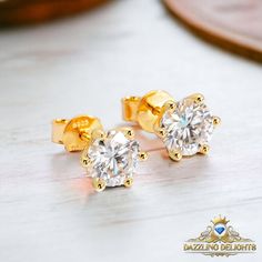 Specifications: Metal: 18K White Gold Over 925 Sterling Silver | 18K Yellow Gold Over 925 Sterling Silver Moissanite Shape: Round Brilliant Cut Moissanite Weight: 0.5ct | 1.0ct | 2.0ct Moissanite Size: 5.0mm | 6.5mm | 8.0mm Moissanite Colour: D Moissanite Clarity: VVS1 Moissanite Cut Grade: Excellent What to expect from our Moissanite Jewellery: You can expect only the very best in quality and craftsmanship, and a product which will turn heads wherever you go. Each moissanite comes with a profes Moissanite Jewellery, Moissanite Jewelry, New Classic, Round Brilliant Cut, Jewelry Designs, Round Brilliant, White Gold, 925 Sterling Silver, Yellow Gold