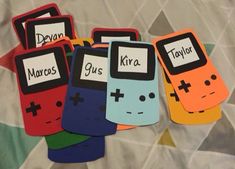 five colorful cell phones are sitting next to each other on a sheet with the words kyra written on them