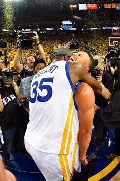 the basketball player is being hugged by fans