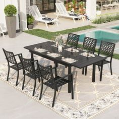 an outdoor dining table with six chairs next to a swimming pool and patio furniture set