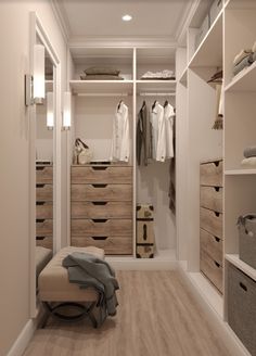 a walk in closet with drawers and clothes