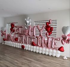 a large balloon sign that says happy valentine's day