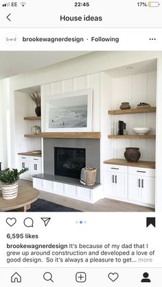 a living room with white cabinets and shelves