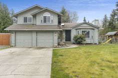 a large house with two garages in the front yard