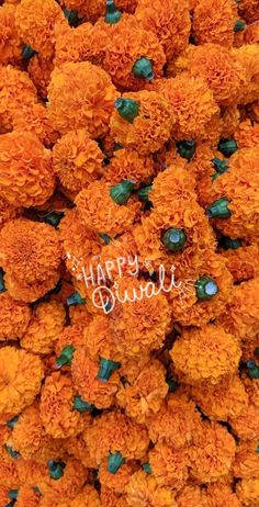 an arrangement of orange flowers with the words happy birthday written on them in white writing