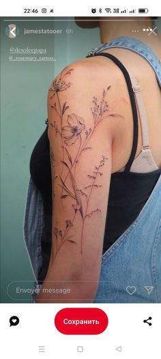 the back of a woman's shoulder with flowers on it and an inscription in russian