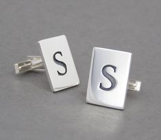 Sleek, modern cufflinks made of sterling silver with a custom monogram of the same letter on each cufflink. Elegant heirloom quality cufflinks for all dress occasions. This listing is for a pair of cufflinks with the same letter.Size is 3/4" X 9/16".  Please see my other listing for cufflinks with two different letters.   Perfect for groomsmens' gifts - Wedding parties discount!  Order more four or more pairs and get one pair at half price! Send me a convo and I will create a custom listing for you with the letters you need.   Entirely hand wrought, not cast or stamped. I shape the the cufflink from a heavy gauge piece of sterling silver. I design the letter and then saw it out, creating the letter in negative space. Next this piece is torch soldered to a second piece of heavy gauge sterli Silver Initials Cufflinks For Formal Wear, Classic Silver Cufflinks With Initials, Silver Initials Cufflinks For Business, Modern Silver Cufflinks Gift, Luxury Sterling Silver Cufflinks For Gift, Monogrammed Cufflinks, Silver Clip-on Cufflinks For Gift, Sterling Silver Mens, Custom Monogram