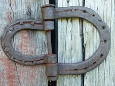 an old rusted metal latch on a wooden door